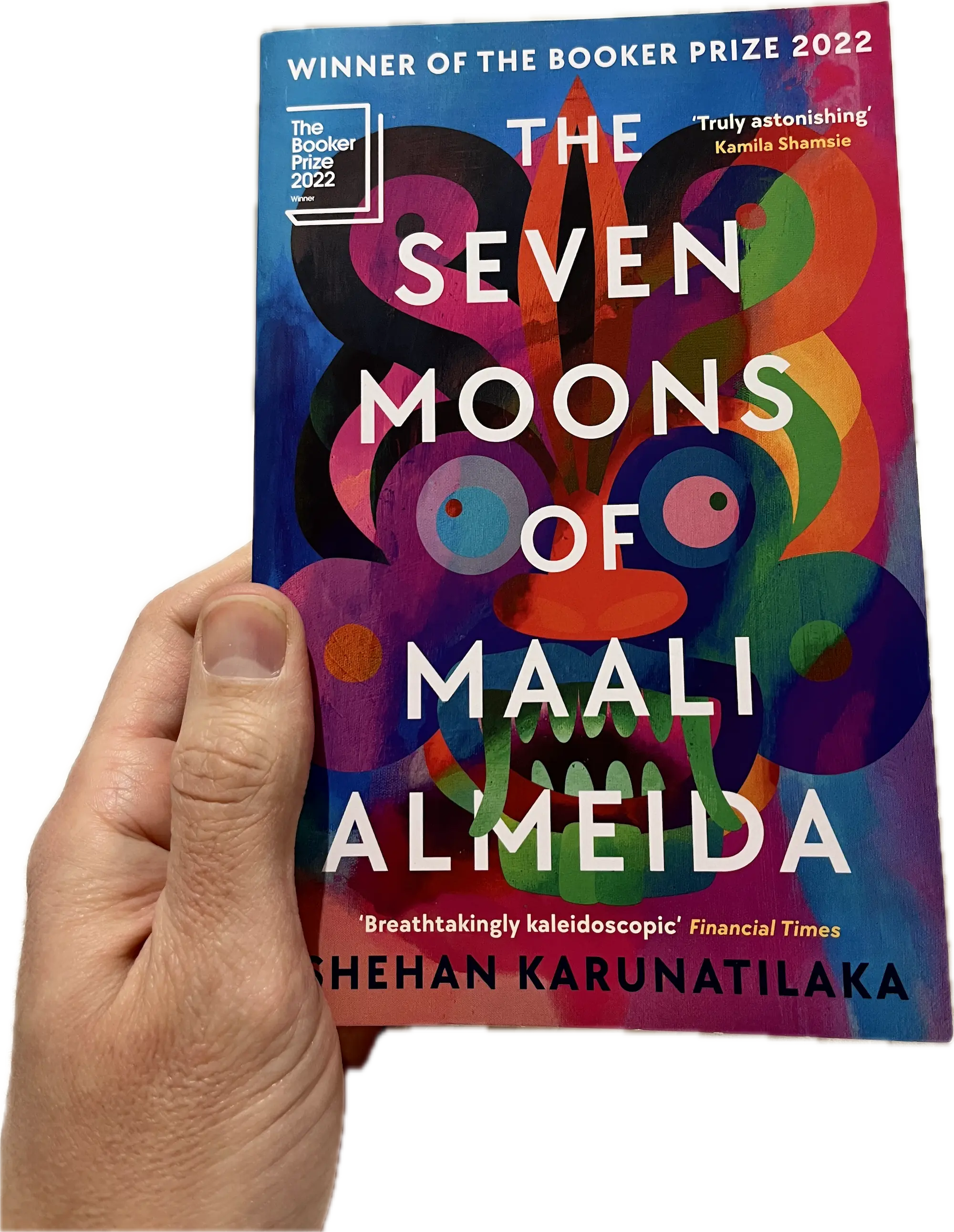 A hand holding a book, The Seven Moons of Maali Almeida