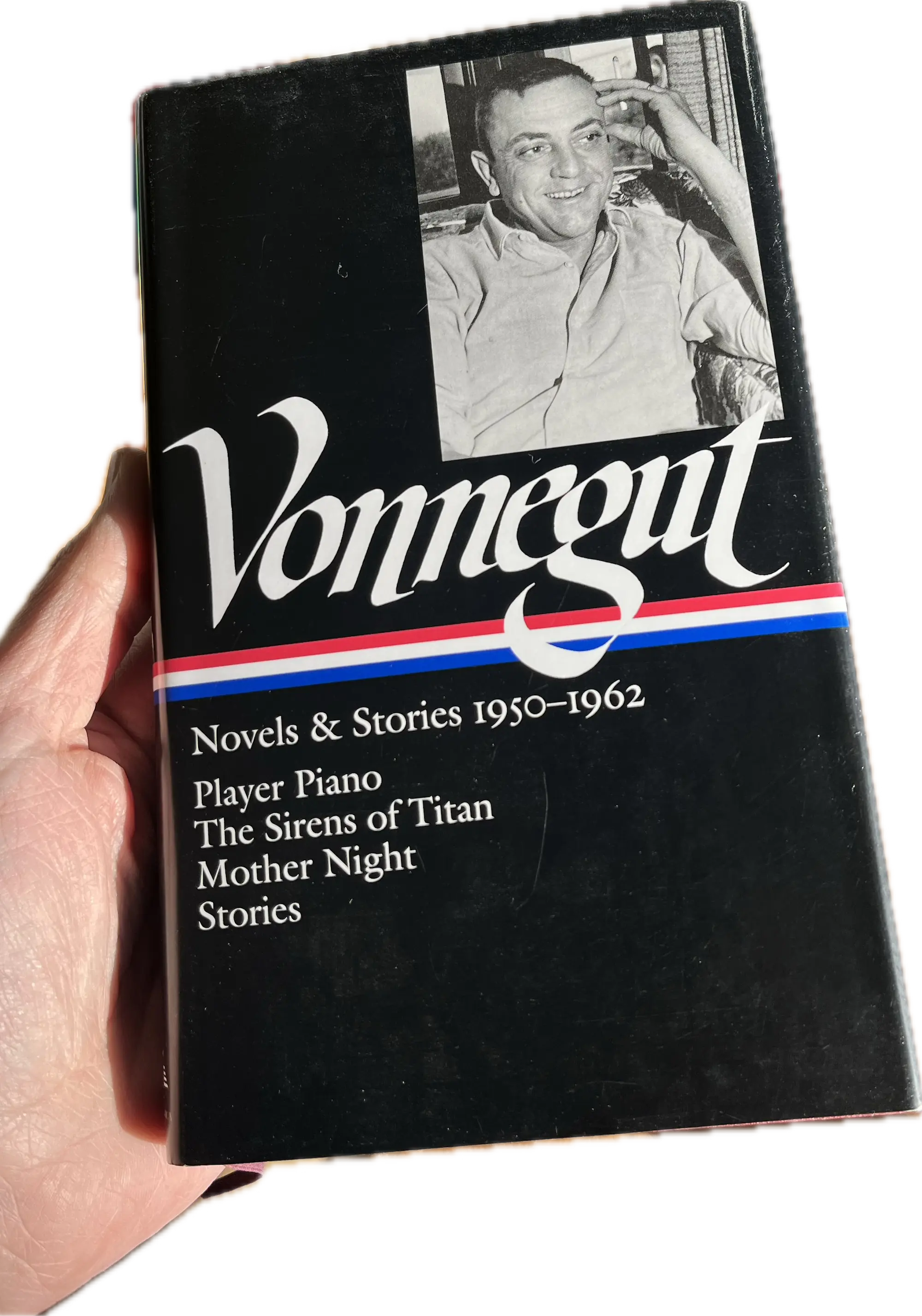 A hand holding a book, Player Piano