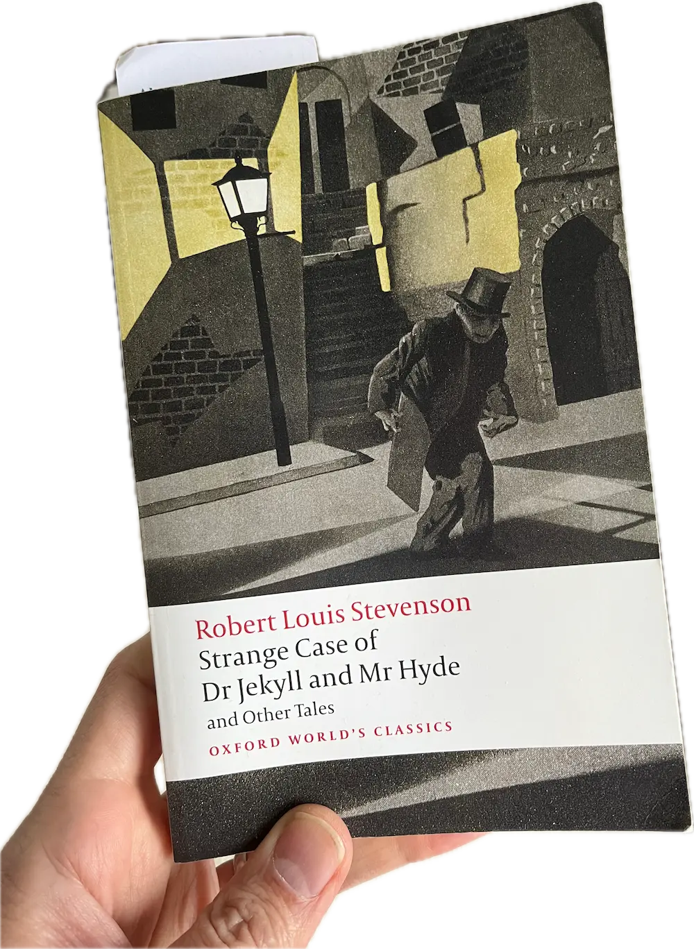 A hand holding a book, Strange Case of Dr Jekyll And mr Hyde