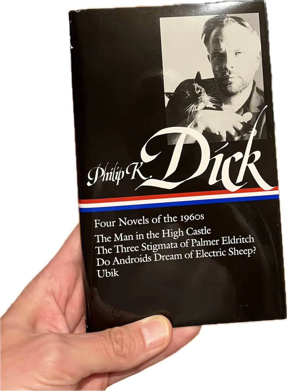 A hand holding a book, Ubik