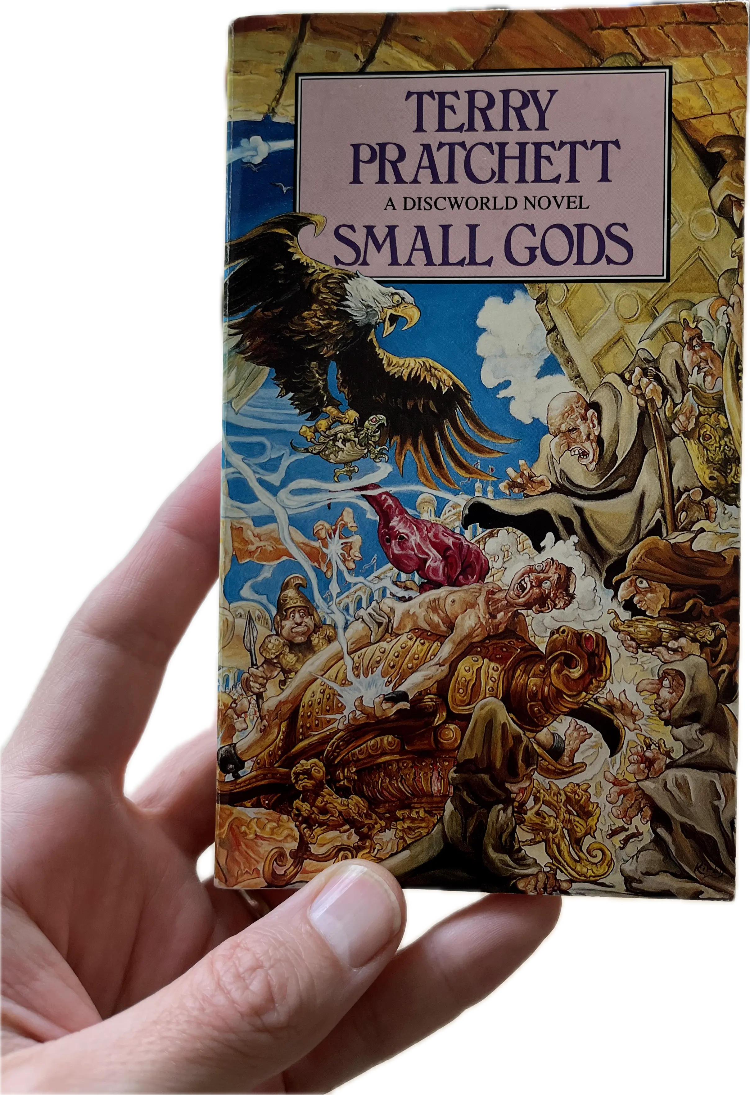 A hand holding a book, Small Gods