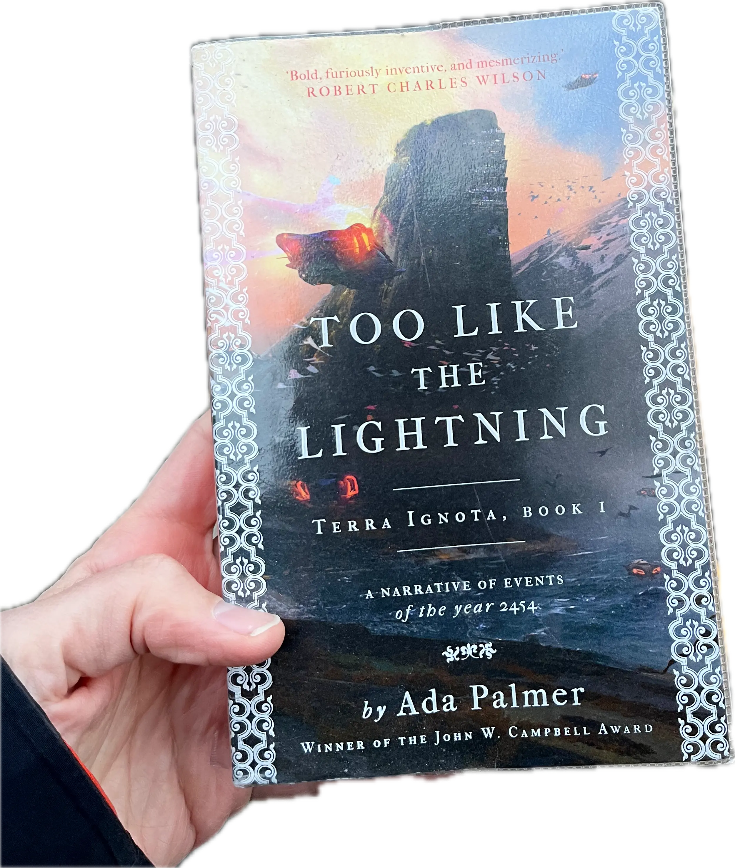 A hand holding a book, Too Like The Lightning