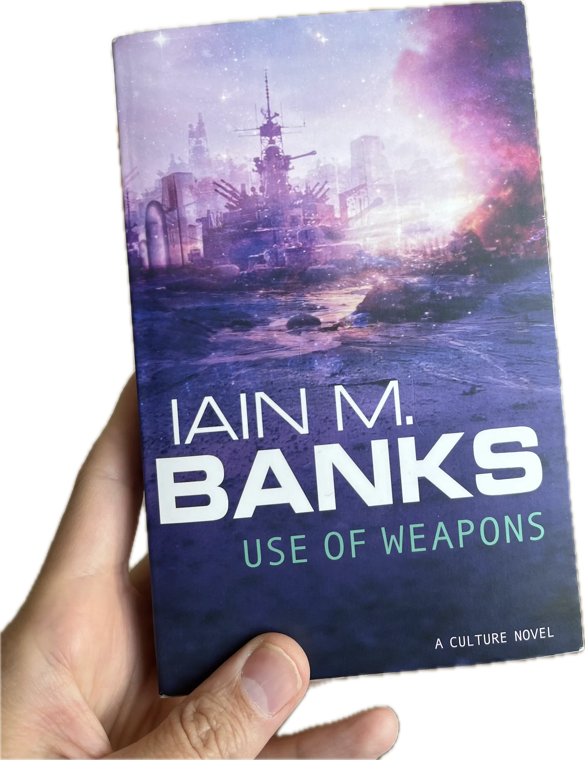 A hand holding a book, Use Of Weapons